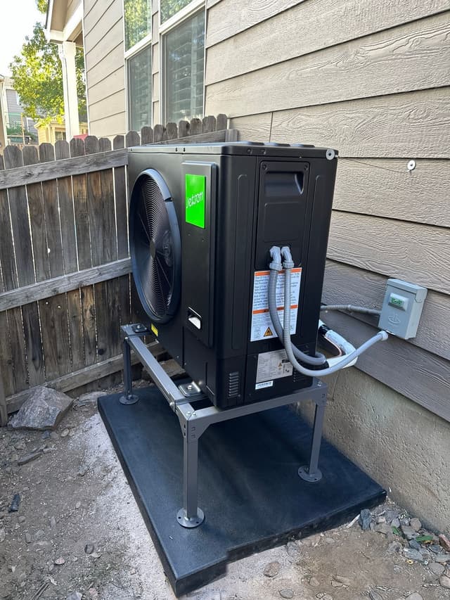 3-ton Jetson Air central ducted heat pump installed in a narrow side yard between a wood privacy fence and gray lap siding in Fort Logan, Denver.
