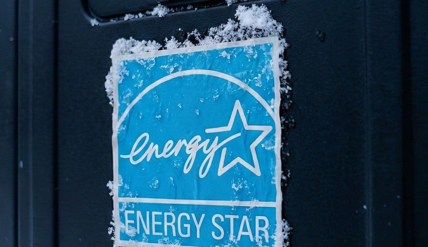 Close-up of the snow-dusted ENERGY STAR certification label on a Jetson heat pump
