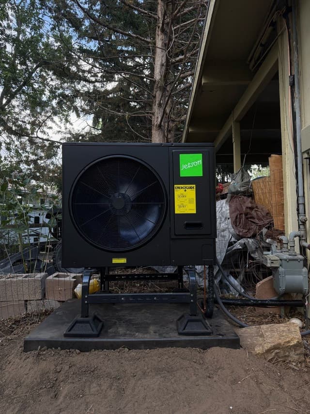 Newly installed central ducted heat pump outside a home in Greeley, Colorado.