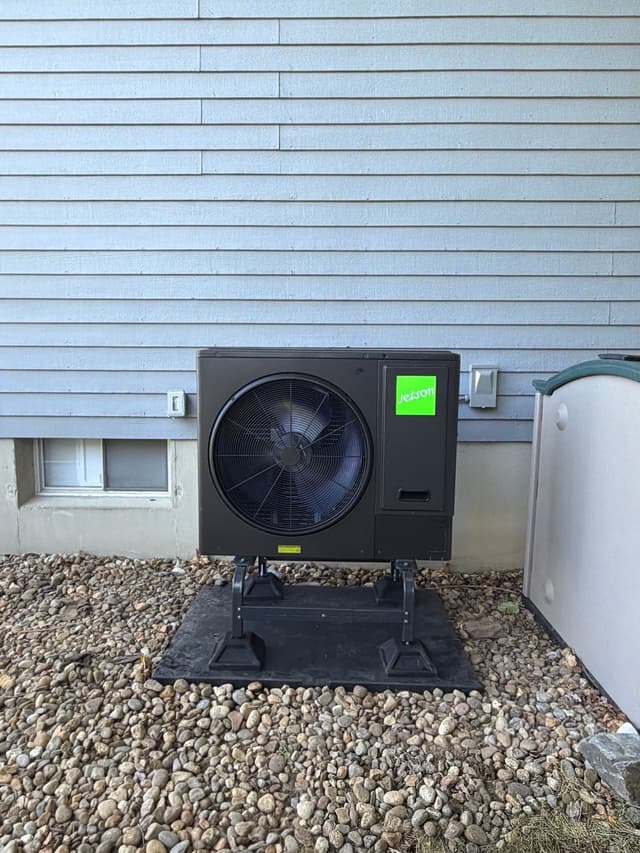 Jetson Air 3-ton central ducted heat pump condenser installed along the side of a gray-sided house in Haverhill, MA, with the Jetson logo visible on the unit.