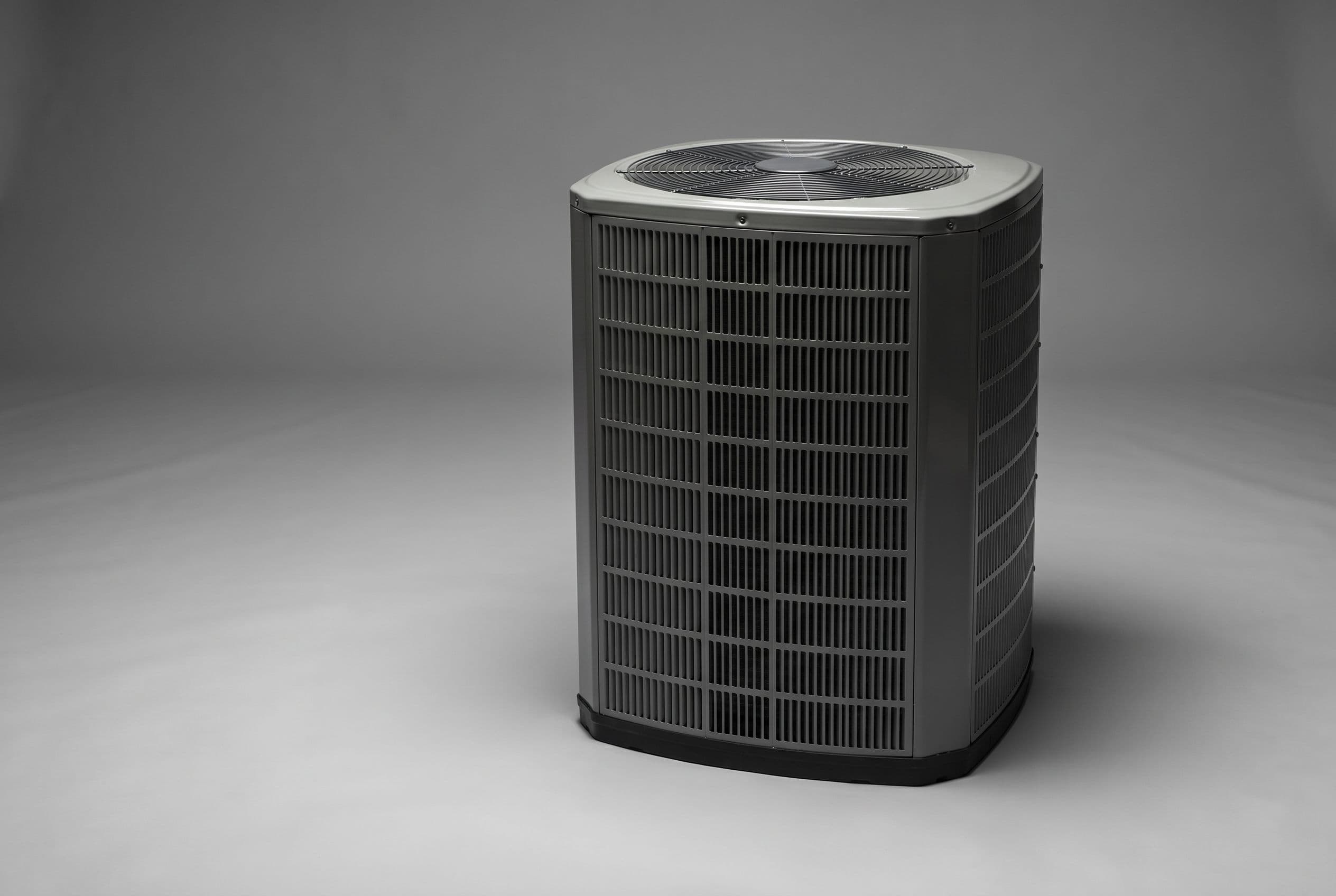 Studio photograph of an American Standard heat pump outdoor unit