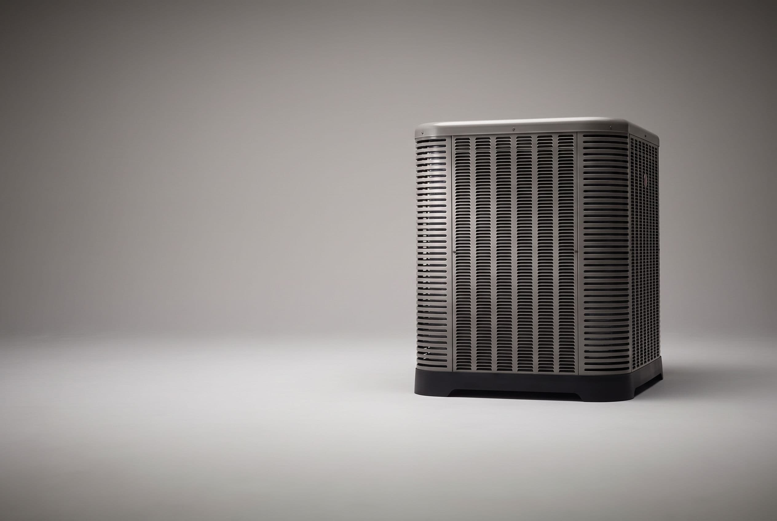 Studio photograph of a Rheem heat pump outdoor unit