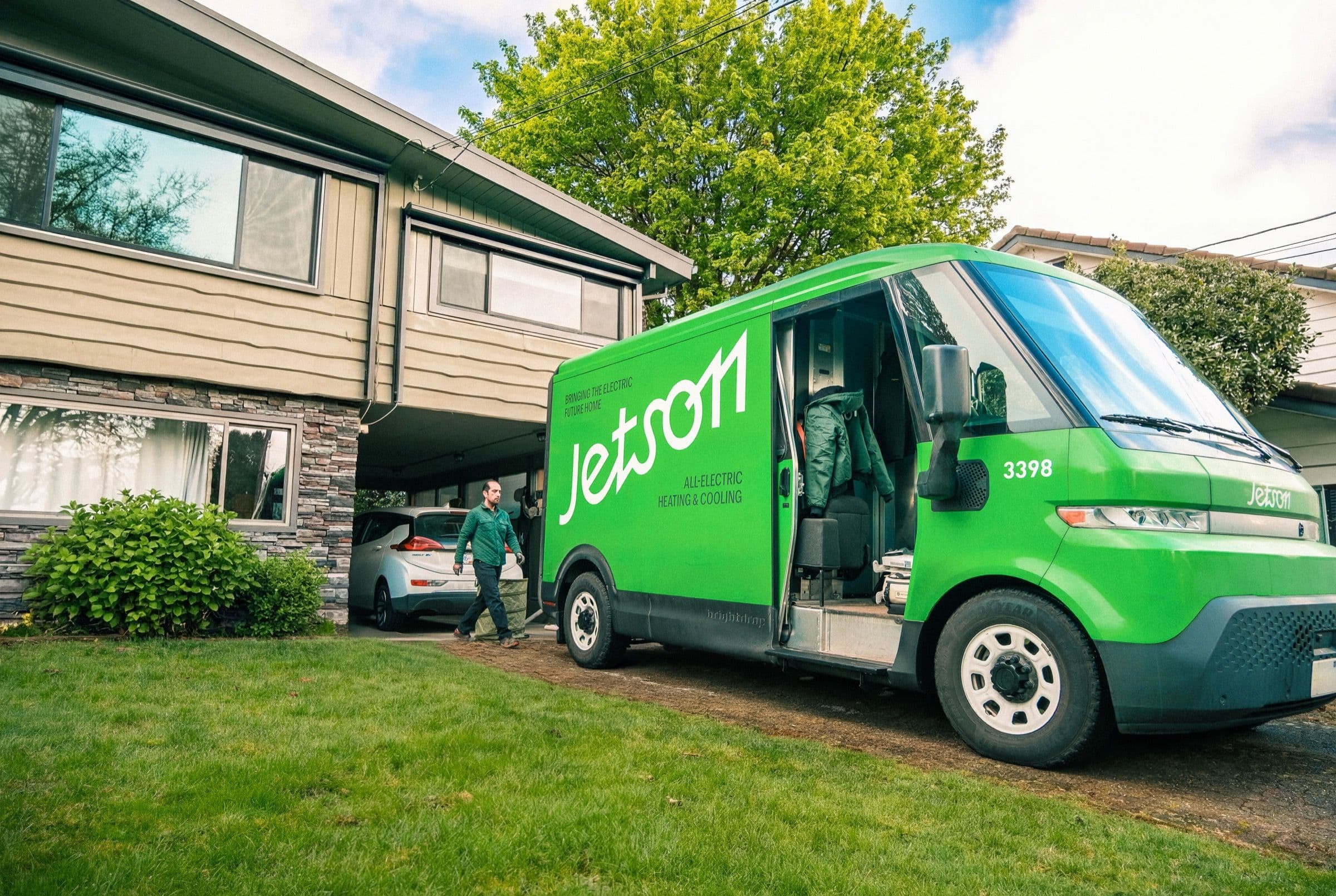 Jetson-branded electric installation van parked in front of a suburban home