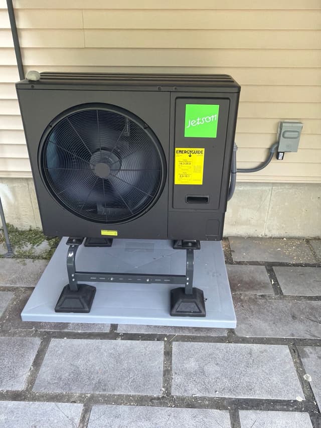 Jetson Air 3-ton central ducted heat pump unit installed against tan vinyl siding of a home in Leominster, Massachusetts.