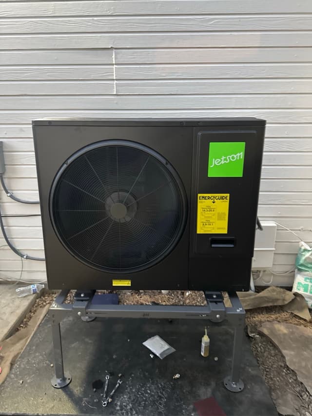 Jetson Air 3-ton central ducted heat pump installed against white horizontal siding at a home in Longmont, Colorado.