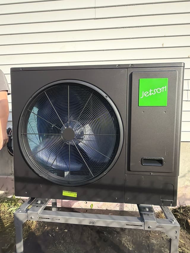3-ton Jetson Air central ducted heat pump installed against white vinyl siding of a home in Medford, MA.