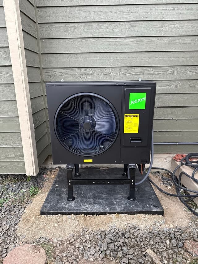 Jetson Air 3-ton outdoor heat pump unit installed beside gray lap siding at a home in Westminster, MA.