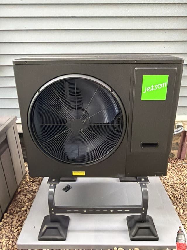 Jetson Air 3-ton central ducted heat pump outdoor unit installed against gray vinyl siding at a Winchester home.