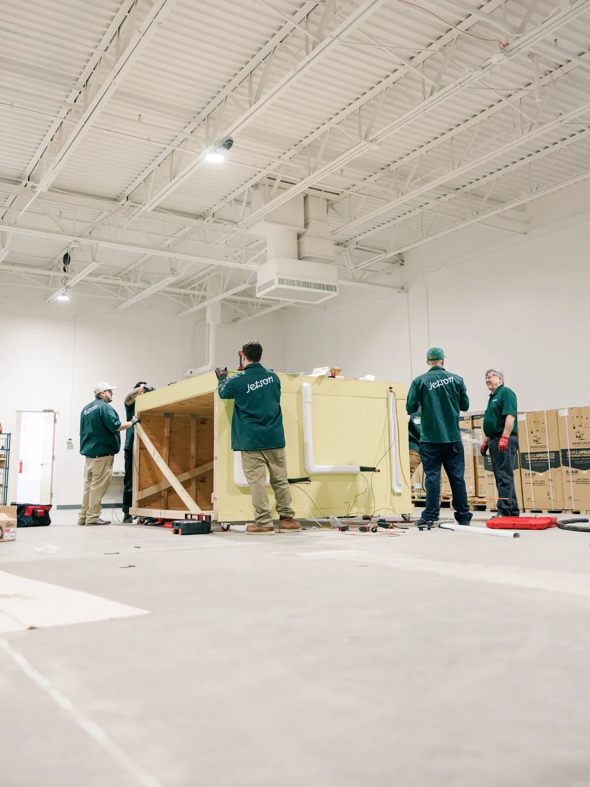 Jetson technicians working on a practice install in the training warehouse