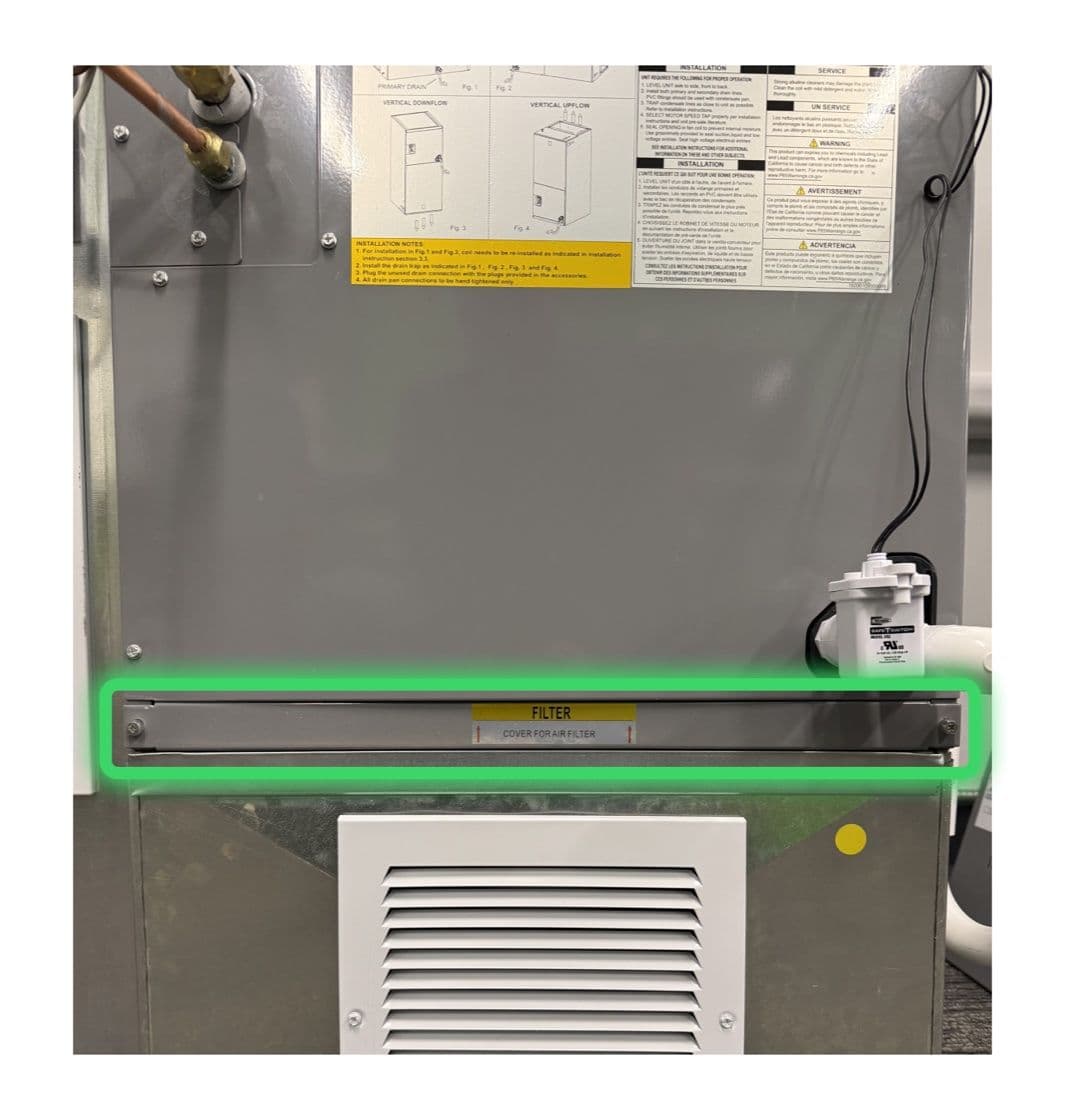 The air filter cover on the front of the indoor unit, highlighted in green.