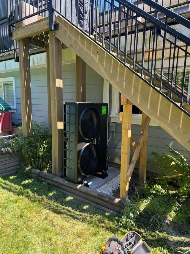 4-ton Jetson heat pump installed under a staircase against a home in Ladner, Delta, BC.
