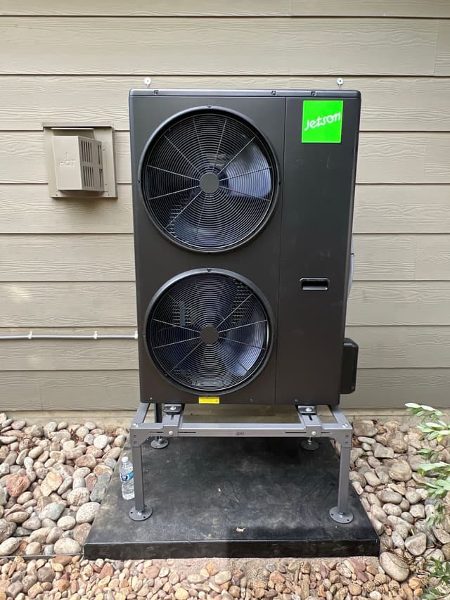4-ton Jetson Air central ducted heat pump installed against tan lap siding at a home in Erie, CO.