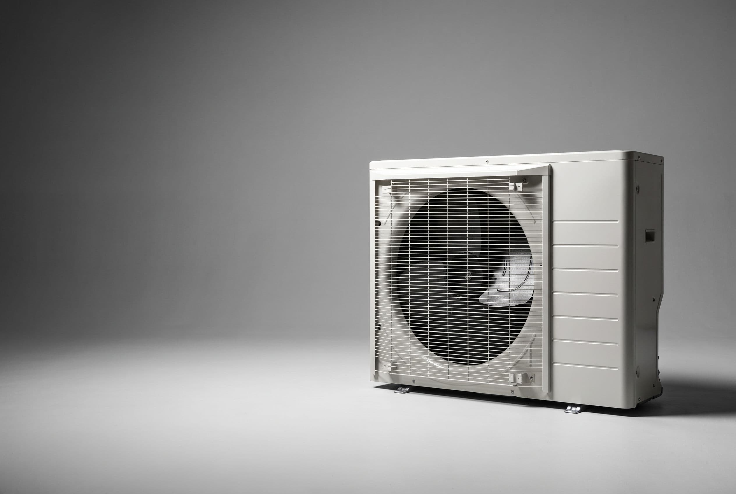 Studio photograph of a Daikin heat pump outdoor unit
