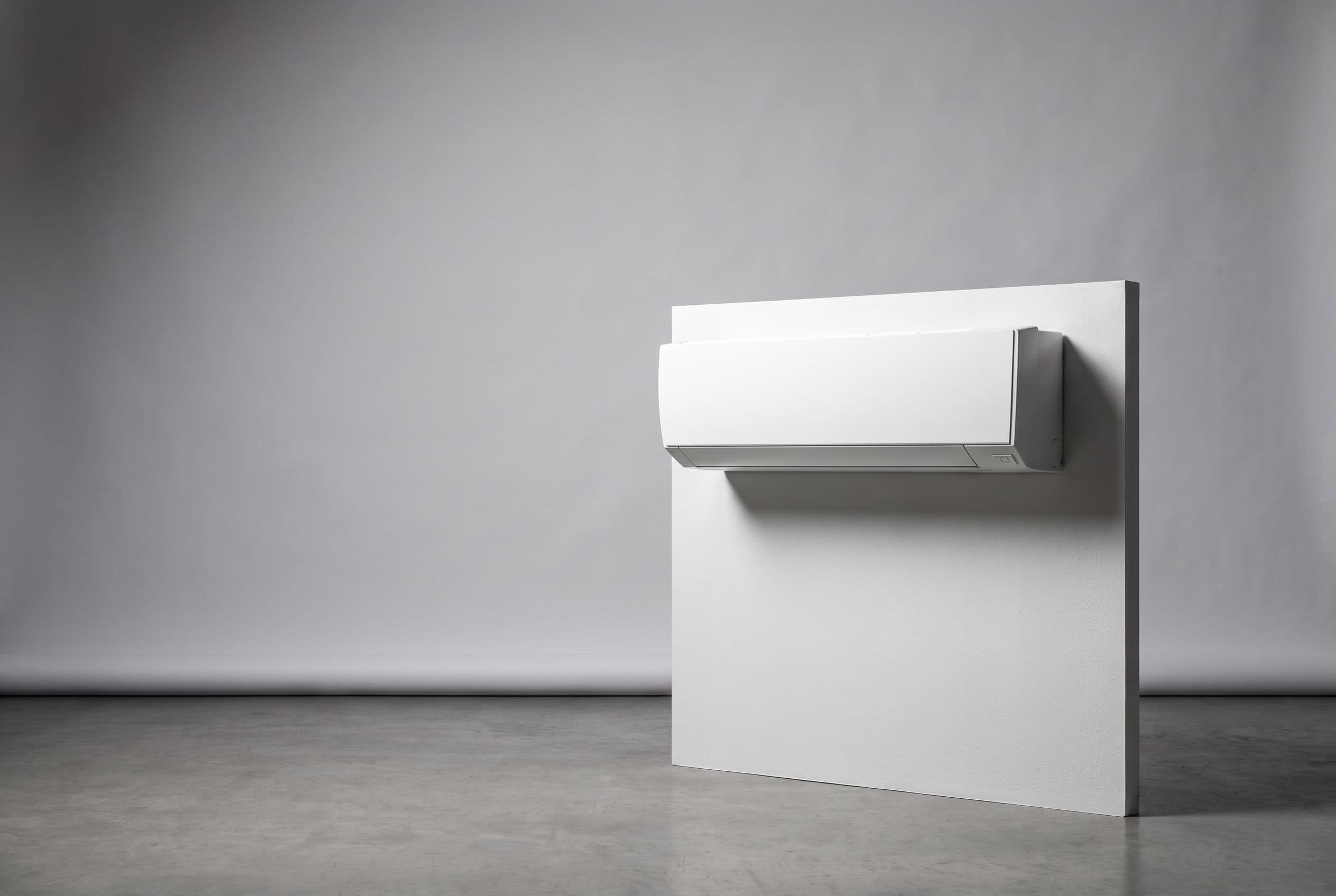 Studio photograph of a Fujitsu heat pump outdoor unit