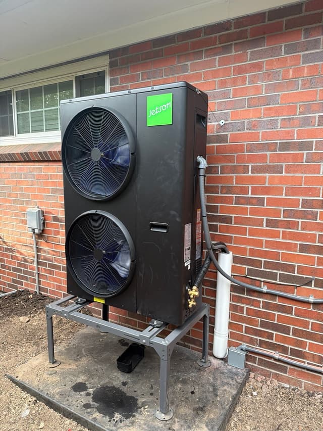 4-ton Jetson Air ducted heat pump unit mounted against a red brick exterior wall at a home in Lakewood.