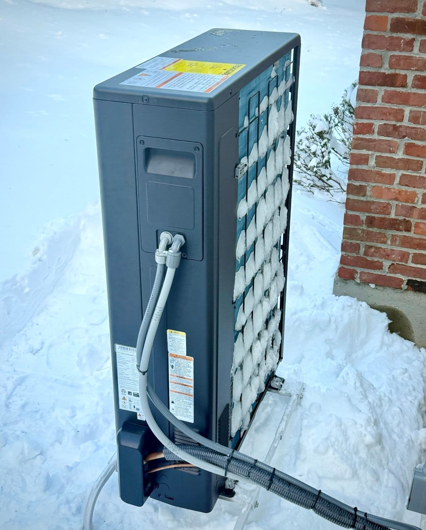 Normal frost buildup on the outdoor unit in cold or humid conditions.