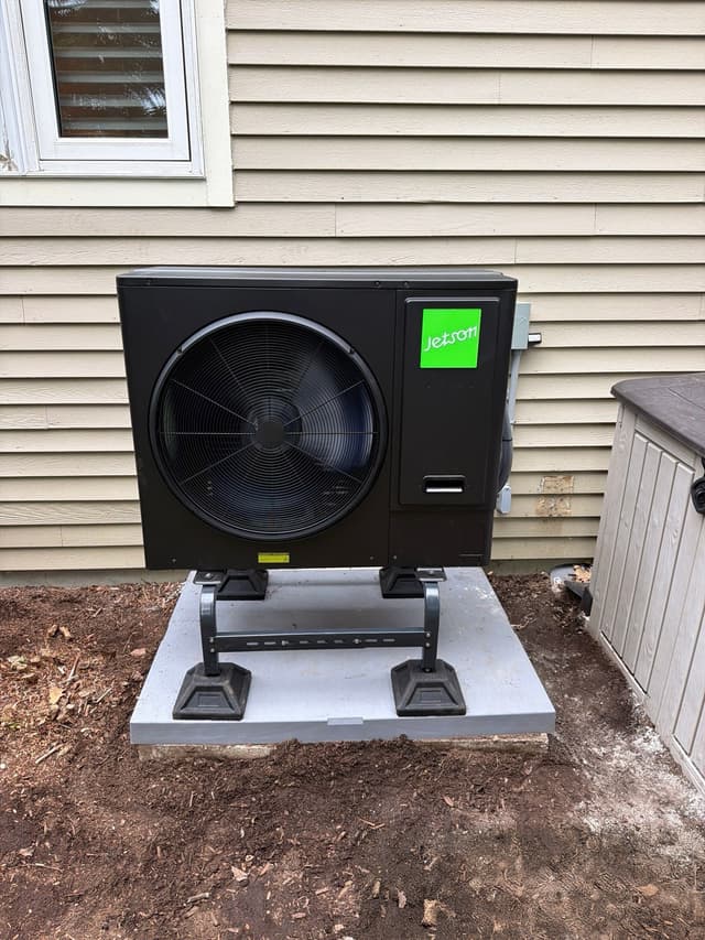 Jetson Air 3-ton central ducted heat pump condenser installed against tan vinyl siding at a home in Northborough, MA.